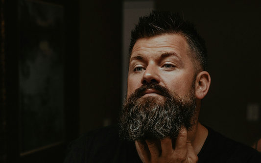 A Man Grooming and Styling his Beard Using Pomp & Co Beard Products